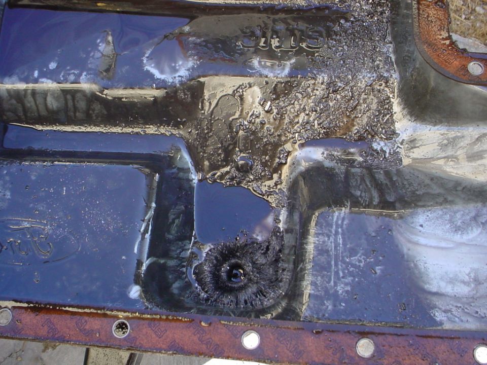 Oil pan with a hole and visible text 'SUPERMOTORS'