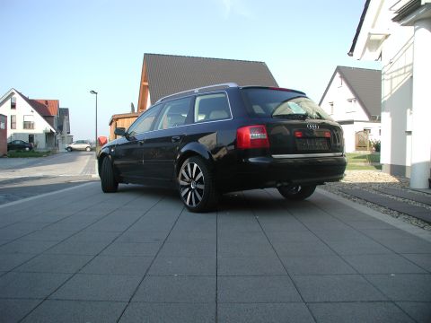 2003 Audi A6 - A black 2003 Audi A6 wagon is parked in front of a modern house on a sunny day.