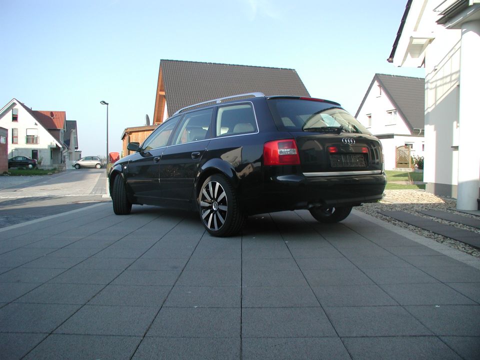 Black 2003 Audi A6 wagon parked on a paved driveway, rear 3/4 view