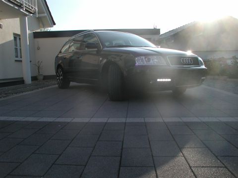 2003 Audi A6 - A black 2003 Audi A6 Avant is parked on a paved driveway in front of a house.