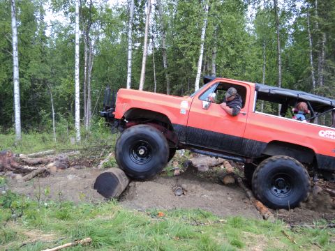 1990 Chevrolet Suburban - This 1990 Chevrolet Suburban navigates a challenging off-road course with large tires and a lifted suspension.