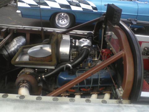 1960 Ford Falcon - Engine bay of a custom race car, with a blue car visible in the background.