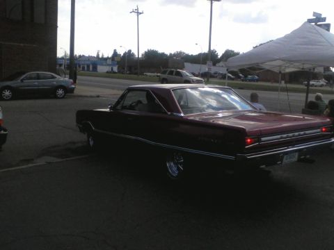 1960 Ford Falcon - This maroon 1966 Dodge Charger coupe is seen from the rear 3/4 angle.
