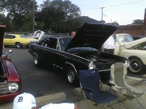 1960 Ford Falcon - Several classic cars are parked outside with their hoods open, suggesting a car show or gathering.