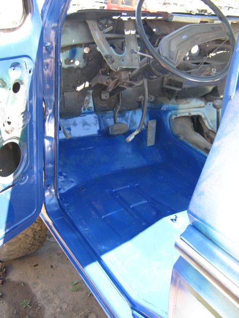1978 Ford Bronco - Interior view of a 1978 Ford Bronco showing the blue painted floor and partially disassembled dashboard.