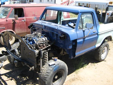 1978 Ford Bronco - A blue pickup truck, likely from the 1970s, is shown with its engine compartment disassembled.