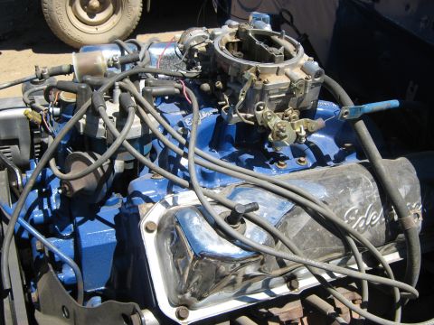 1978 Ford Bronco - Close-up view of a blue engine chrome valve covers and a carburetor, likely from a classic vehicle.