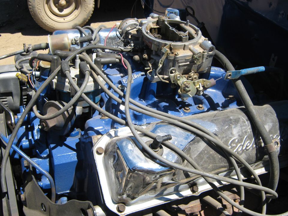 Blue engine with chrome valve covers and a carburetor