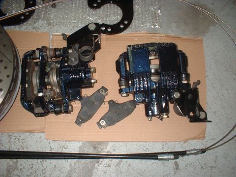 1969 Ford Torino - Car brake calipers and a rotor are laid out on cardboard.