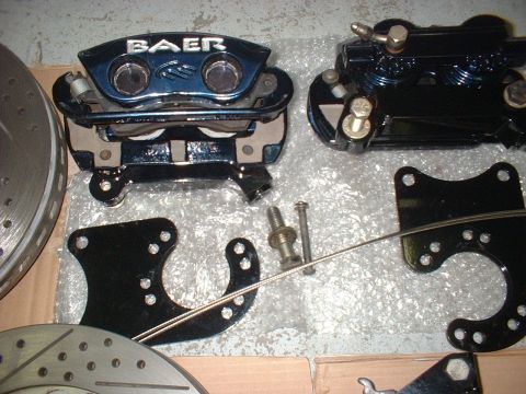 1969 Ford Torino - Close-up of automotive brake components, including calipers and rotors, laid out on a surface.