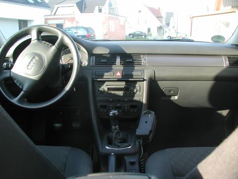 2003 Audi A6 - The interior of a 2003 Audi A6 is visible, including the dashboard, steering wheel, and center console.