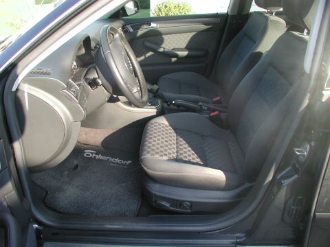 2003 Audi A6 - The interior of a car is shown, the front seats, dashboard, and a custom floor mat with the name 'Ohlendorf'.