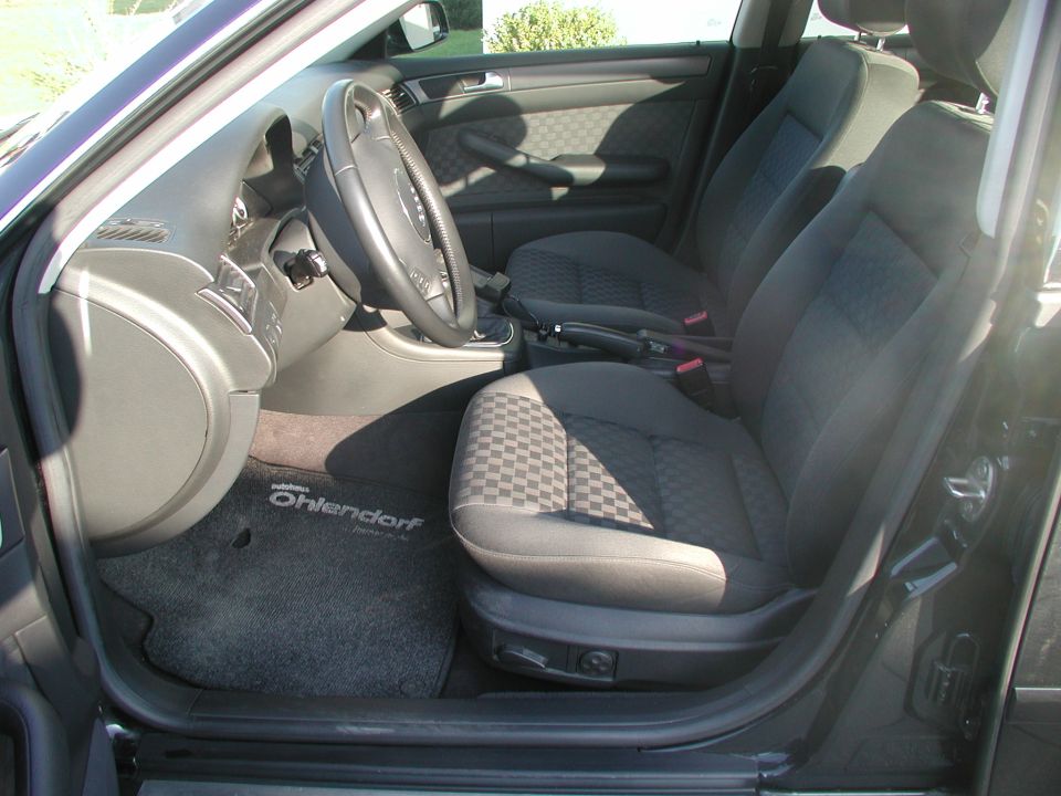 Interior view of car seats and dashboard with 'Ohlendorf' floor mat