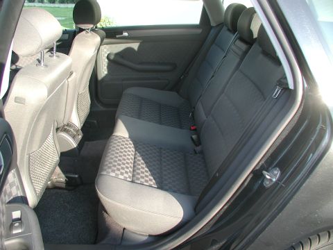 2003 Audi A6 - Interior view of the rear seats in a 2003 Audi A6, checkered fabric upholstery.