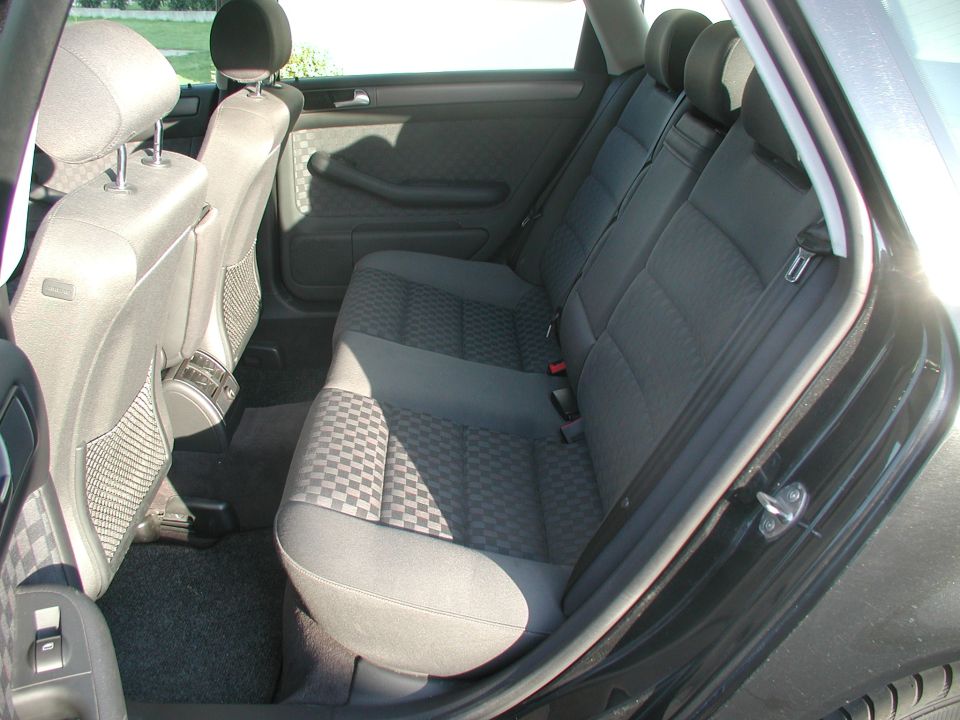 Rear bench seat interior with black checkered-pattern cloth upholstery
