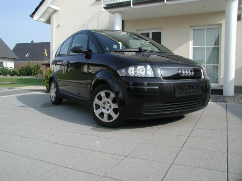 2001 Audi A4 - A black hatchback with a unique body style is parked in front of a modern house.