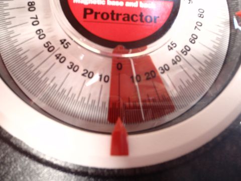 1994 Ford Bronco - A close-up of a protractor shows its measurement markings and a red needle indicating an angle.