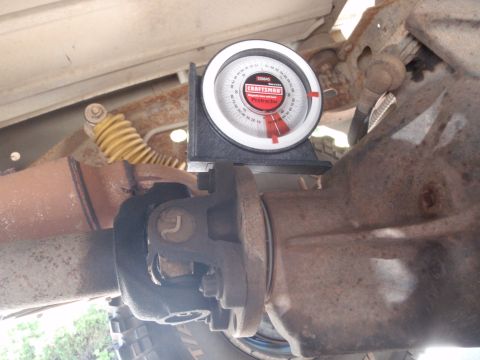 1994 Ford Bronco - A Craftsman protractor is used to measure the angle of a vehicle's differential and driveshaft.
