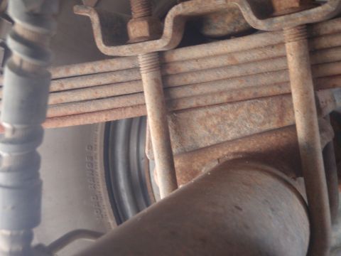 1994 Ford Bronco - The rear suspension shows significant rust on the leaf springs and mounting hardware.
