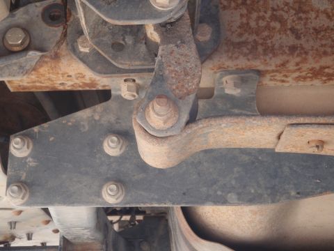 1994 Ford Bronco - Underside view of vehicle suspension components with visible rust and wear.