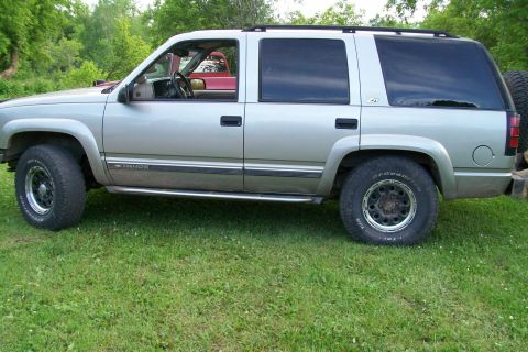 2000 Chevrolet Tahoe - Side view of a silver 2000 Chevrolet Tahoe parked outdoors on a grassy area.