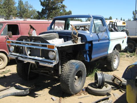 1978 Ford Bronco - This Ford truck, likely from the mid-1970s, is in a state of disrepair with its hood removed.