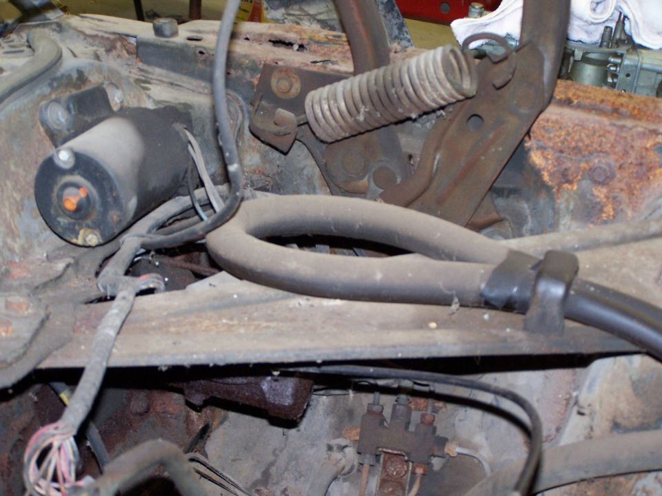 Engine bay components with starter motor and hoses
