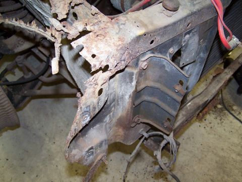 1972 Ford Mustang - Extensive rust damage visible on vehicle frame and suspension parts.