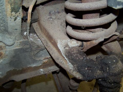 1972 Ford Mustang - This photo shows the underside of a vehicle, focusing on worn and rusty suspension components.