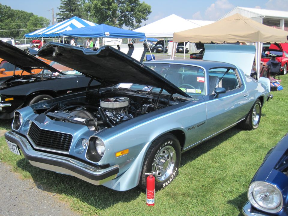 Light blue 1977 Chevrolet Camaro Rally Sport with hood open, showing engine