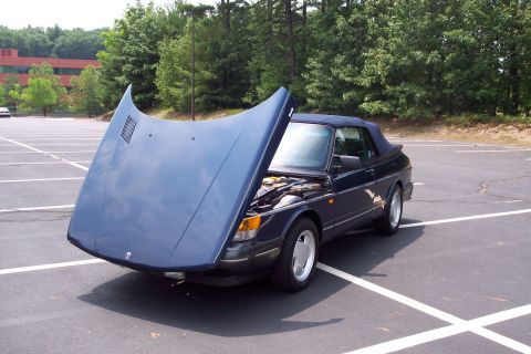 2001 Ford Crown Victoria - A dark blue convertible is parked in a lot with its hood open, revealing the engine compartment.