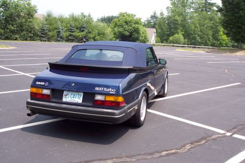 2001 Ford Crown Victoria - This 1992 Saab 900 Turbo Convertible is shown from a rear three-quarter angle in an empty parking lot.