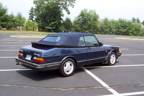 2001 Ford Crown Victoria - This blue 1992 Saab 900 Turbo convertible is seen from the rear three-quarter angle in a parking lot.