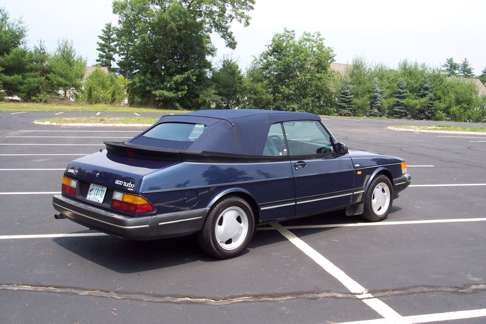 Blue 1992 Saab 900 Turbo convertible parked in a lot, rear 3/4 view