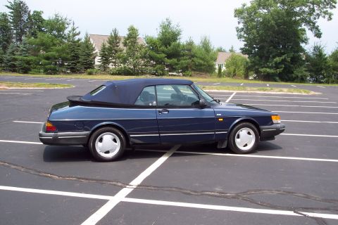 2001 Ford Crown Victoria - Side view of a blue convertible parked in a lot.