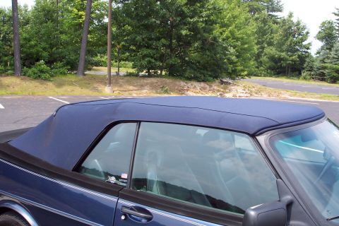 2001 Ford Crown Victoria - Side view of a blue Saab 900 Turbo convertible with the soft top up.