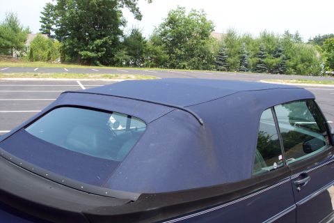 2001 Ford Crown Victoria - The convertible top of a 1992 Saab 900 Turbo Convertible is visible from the side.