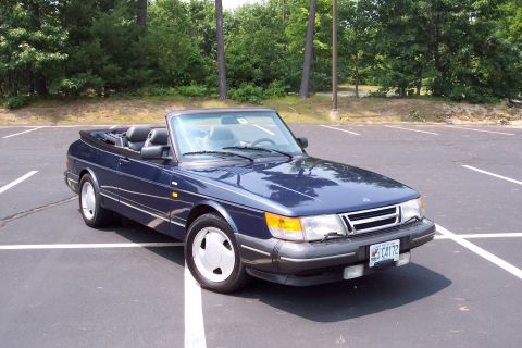 2001 Ford Crown Victoria - A blue convertible is parked in a lot with trees in the background. The license plate reads C4172.