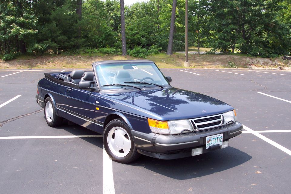 Blue convertible parked in a lot. License plate C4172