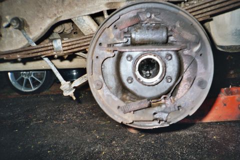1994 Ford Bronco - Close-up of a vehicle's rear drum brake assembly, showing springs and brake shoes.