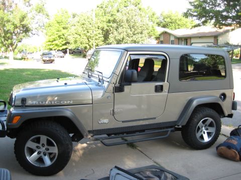2005 Jeep Wrangler - Silver 2005 Jeep Wrangler Rubicon with a grey hardtop parked in a driveway.