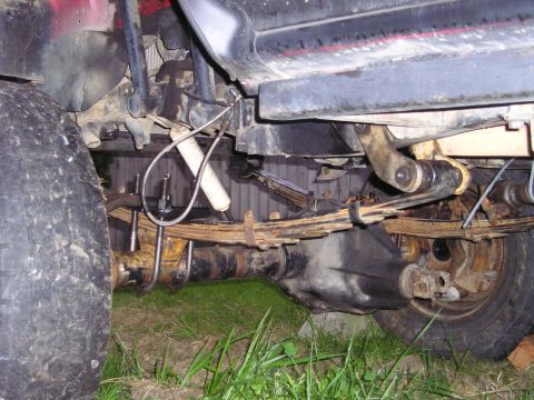 1990 Toyota Pickup/SR5 - Close-up of rear axle and suspension parts, likely from a truck or SUV.