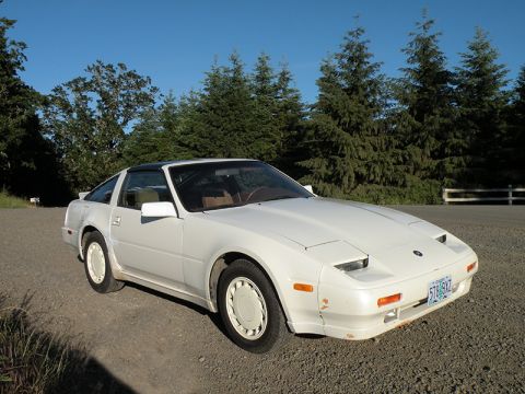1989 Nissan 300ZX - This 1989 Nissan 300ZX is captured in a three-quarter front view, its iconic pop-up headlights and coupe body style.
