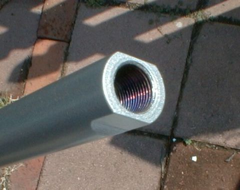 1990 Ford Bronco - A close-up view of a metal rod with a threaded opening, resting on a brick surface.