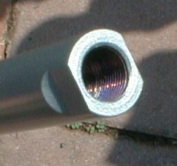 1990 Ford Bronco - Close-up of a threaded pipe fitting, likely a steering component, with SuperMotors.net logo.