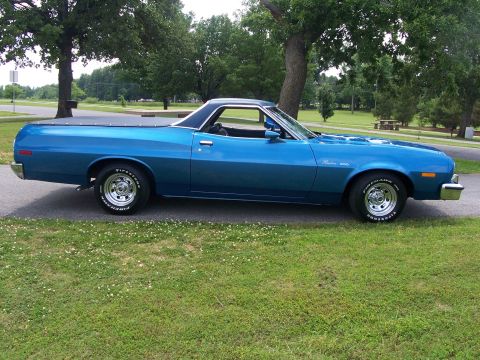 1973 Ford Ranchero - A blue 1973 Ford Ranchero is shown from the side, parked outdoors with a bed cover.