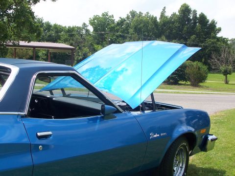 1973 Ford Ranchero - Side view of a blue 1973 Ford Ranchero with its hood open, parked outdoors.