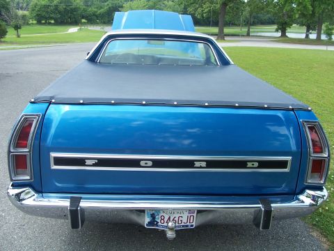 1973 Ford Ranchero - Rear view of a blue 1973 Ford Ranchero pickup truck, a black tonneau cover and the Ford nameplate on the tailgate.