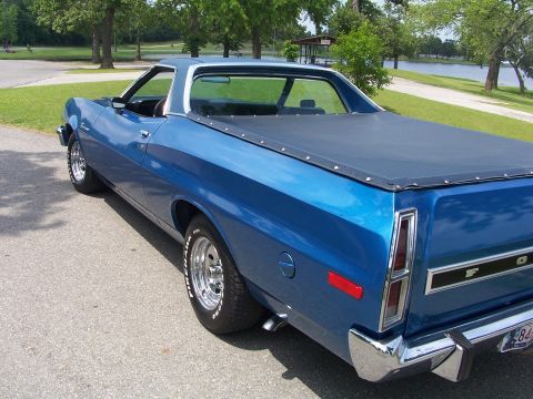 1973 Ford Ranchero - Blue 1973 Ford Ranchero parked outdoors with a lake and trees in the background.