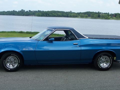 1973 Ford Ranchero - Side profile of a blue 1973 Ford Ranchero pickup truck parked by a lake.